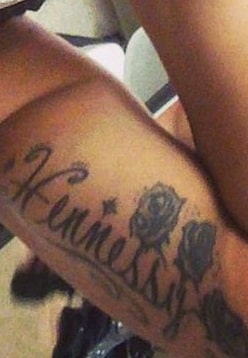 A picture of Hennessy tattoo on Cardi B's left bisceps.